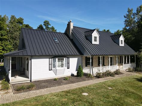 white house with black metal roof|white house with galvalume roof.